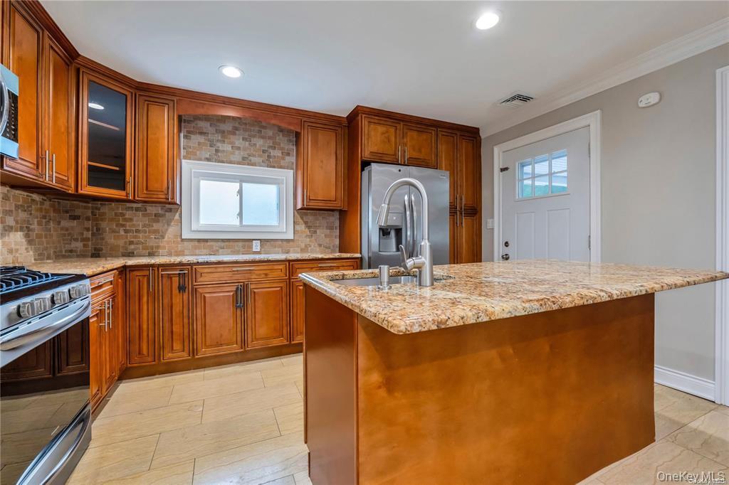 531 Old Country Road Plainview, NY 11803 - Photo 6 of 28 a kitchen with stainless steel appliances granite countertop a sink stove and cabinets