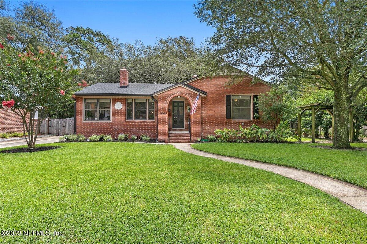 1445 Nicholson Road Jacksonville, FL 32207 - Photo 1 of 31 a front view of a house with a garden and yard