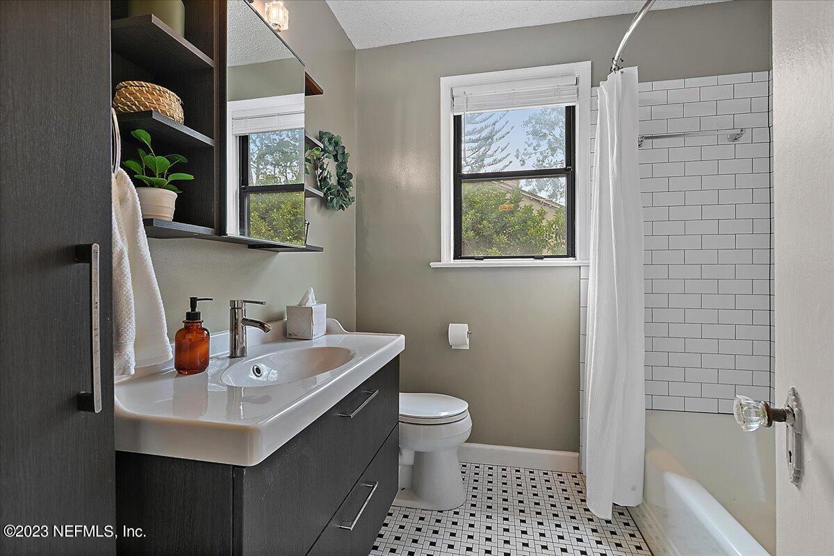 1445 Nicholson Road Jacksonville, FL 32207 - Photo 22 of 31 a bathroom with a sink a toilet and shower