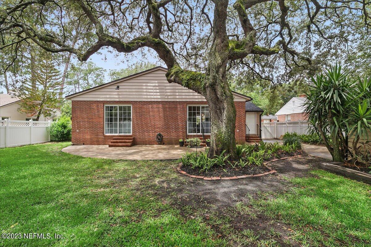 1445 Nicholson Road Jacksonville, FL 32207 - Photo 29 of 31 a front view of a house with a garden and yard