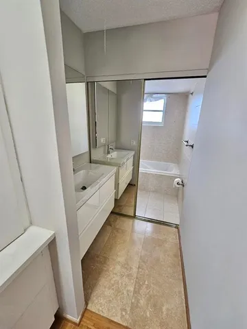a bathroom with a sink a toilet and mirror