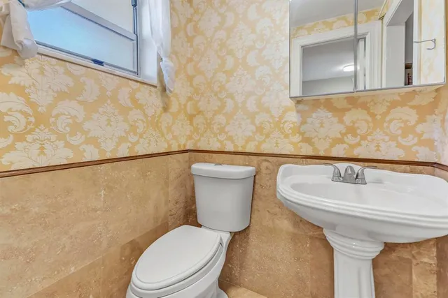 a white toilet sitting next to a bathroom sink