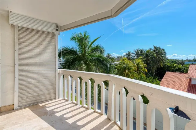 a view of a balcony with wooden floor and fence