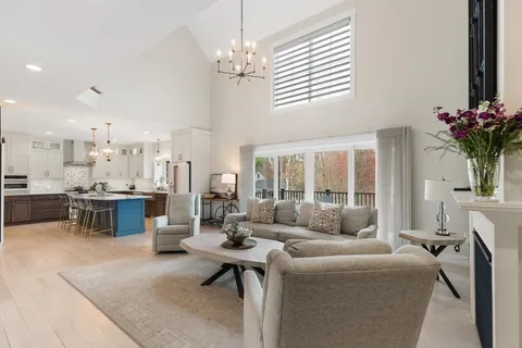 a living room with furniture and a chandelier
