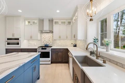 a kitchen with stainless steel appliances granite countertop a sink and stove
