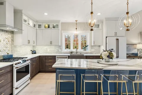 a kitchen with stainless steel appliances granite countertop a sink and stove