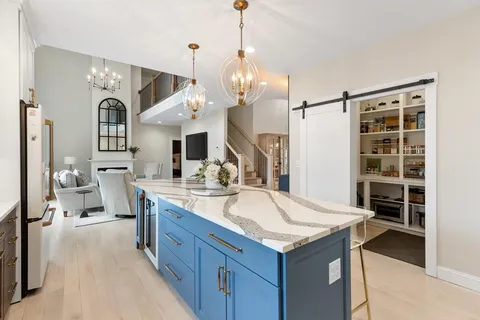 a kitchen with center island table and chairs