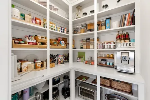 a cabinet with a book shelf and a shelf with books