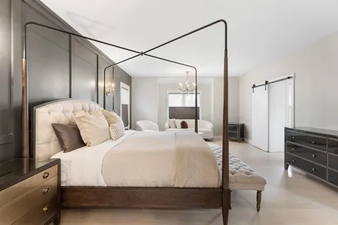 a large white bed in a white room