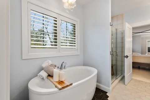 a white bath tub sitting next to a white sink