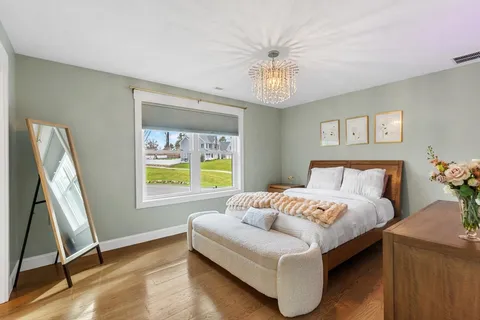 a bedroom with a bed and a large window