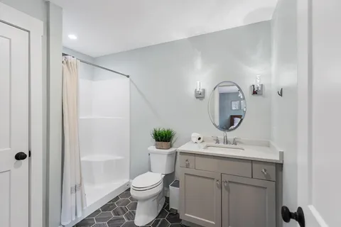 a bathroom with a toilet sink and mirror