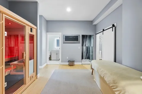 a spacious bedroom with a bed and a mirror