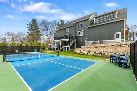 a view of a house with swimming pool and yard
