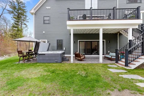 a view of a house with a backyard and porch