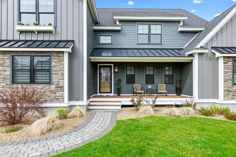 a view of a house with sitting area and swimming pool