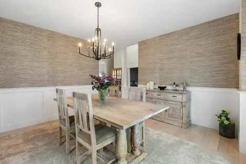 a view of a dining room with furniture and chandelier