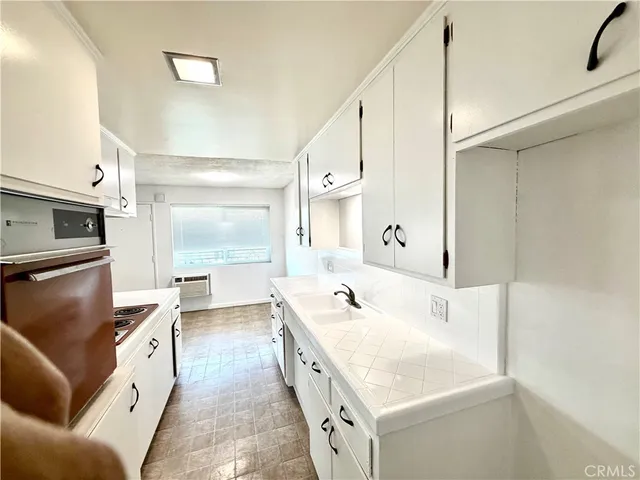 a spacious bathroom with a tub sink and mirror