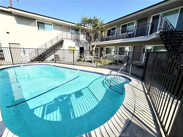 a swimming pool with outdoor seating and yard