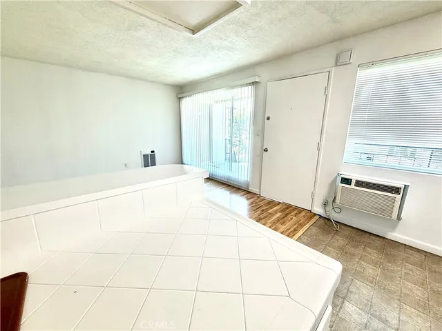 a view of a room with wooden floor and cabinet