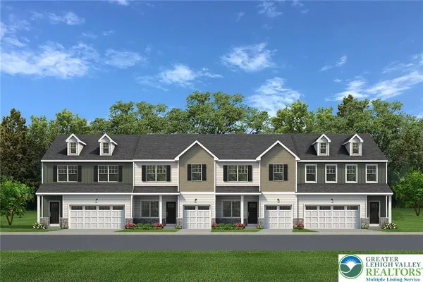a view of a big yard in front of a brick house with a large tree