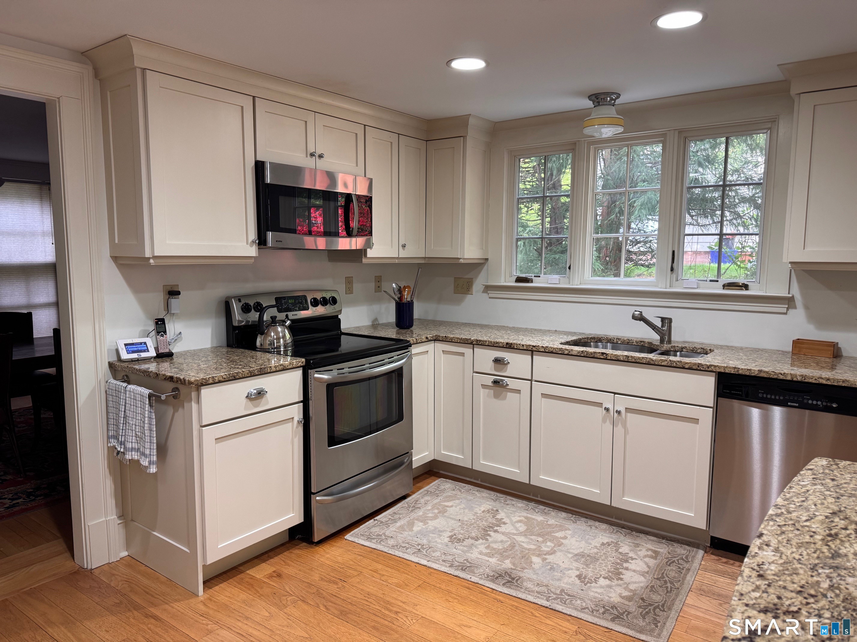 57 Mill Rock Road Hamden, CT 06517 - Photo 10 of 24 a kitchen with granite countertop a sink cabinets stainless steel appliances and a window