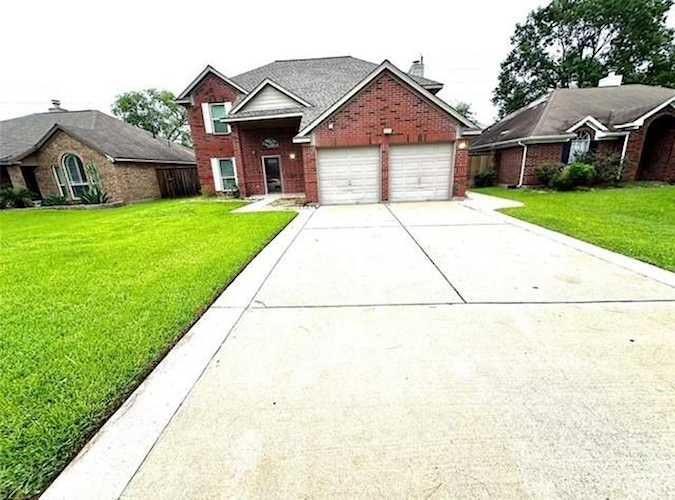 16918 Blend Stone Houston, TX 77084 - Photo 1 of 18 a front view of a house with garden