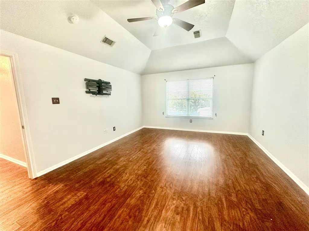 16918 Blend Stone Houston, TX 77084 - Photo 14 of 18 wooden floor in an empty room with a window