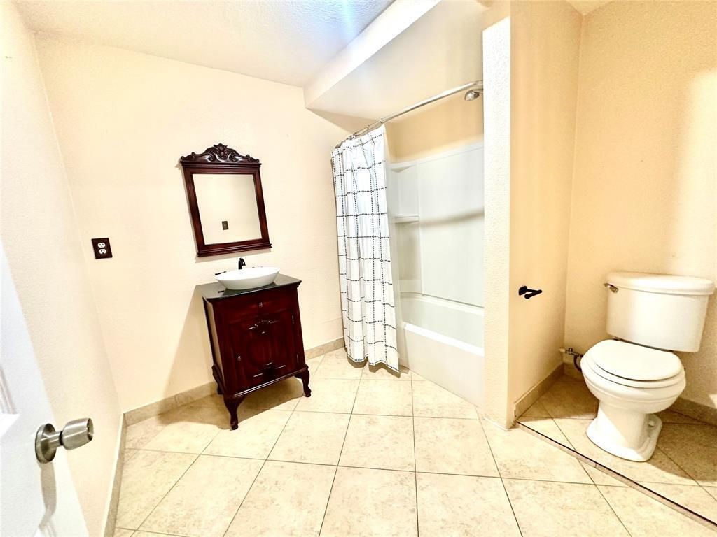 16918 Blend Stone Houston, TX 77084 - Photo 16 of 18 a bathroom with a toilet and a shower