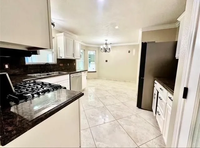 a kitchen with granite countertop a stove and a refrigerator