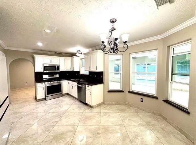 16918 Blend Stone Houston, TX 77084 - Photo 7 of 18 a large kitchen with granite countertop a stove and cabinets