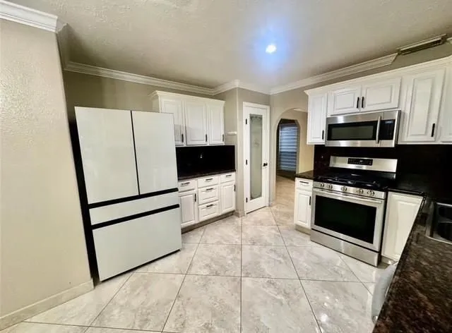 a kitchen with stainless steel appliances a refrigerator stove microwave and sink