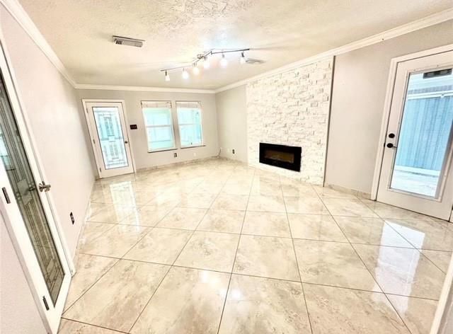 16918 Blend Stone Houston, TX 77084 - Photo 9 of 18 a view of empty room with wooden floor and fireplace