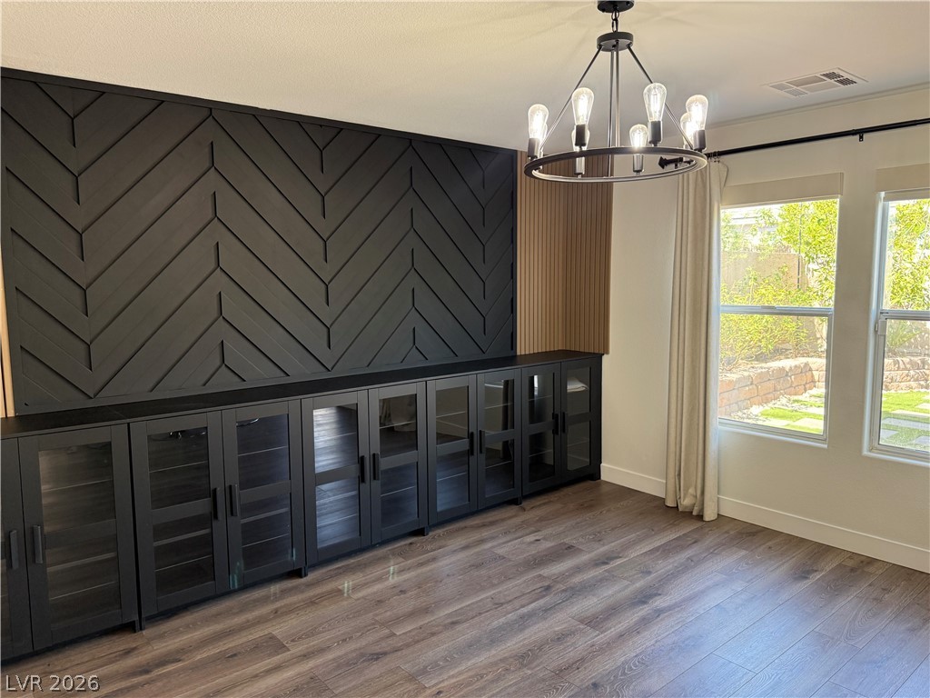 1141 Cathedral Ridge Street Henderson, NV 89052 - Photo 15 of 77 This versatile space features distinctive accent walls and durable flooring, ideal for various uses.