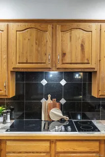 a kitchen with stainless steel appliances granite countertop wooden cabinets a dining table and chairs