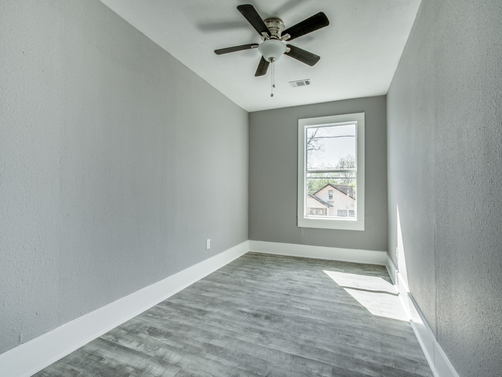 810 Maltby Street, Unit 2 Houston, TX 77011 - Photo 24 of 24 an empty room with a window and a fan