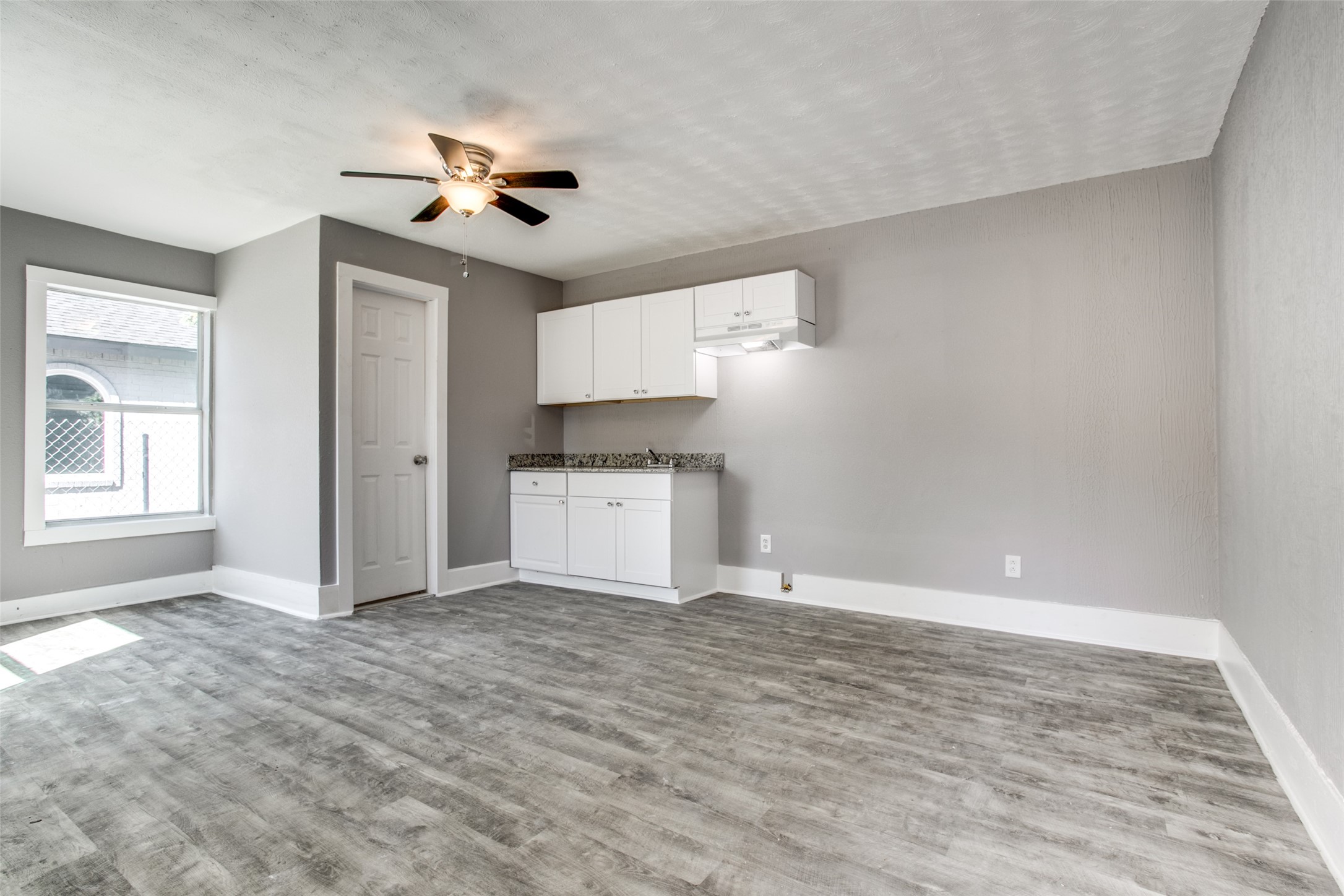 810 Maltby Street, Unit 2 Houston, TX 77011 - Photo 7 of 24 a view of a kitchen with a sink cabinets and window