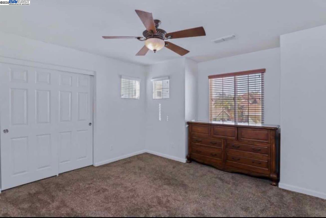 557 Stetson Drive Oakdale, CA 95361 - Photo 7 of 8 a bed room with a bed and a window
