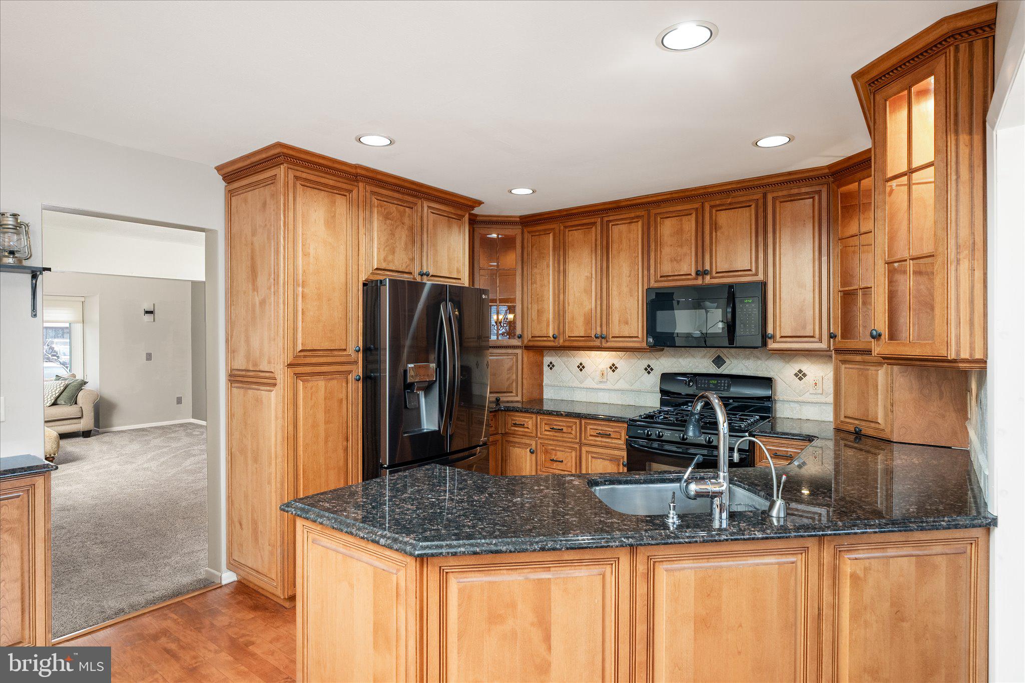 766 Twin Rivers Drive North East Windsor, NJ 08520 - Photo 13 of 31 a kitchen with kitchen island granite countertop a refrigerator a stove and a sink
