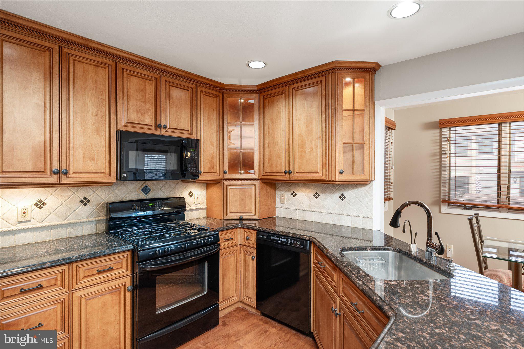 766 Twin Rivers Drive North East Windsor, NJ 08520 - Photo 14 of 31 a kitchen with granite countertop a stove sink and microwave