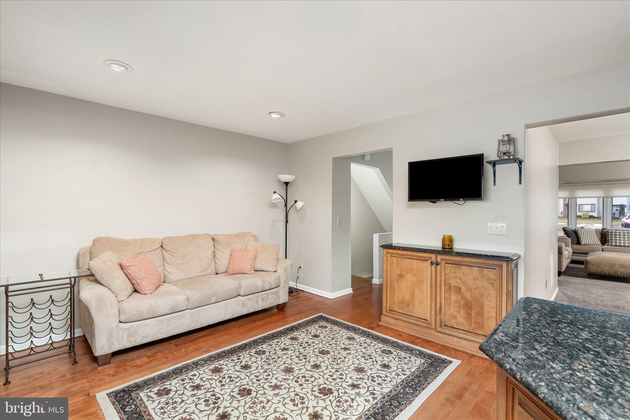 766 Twin Rivers Drive North East Windsor, NJ 08520 - Photo 16 of 31 a living room with furniture and a flat screen tv