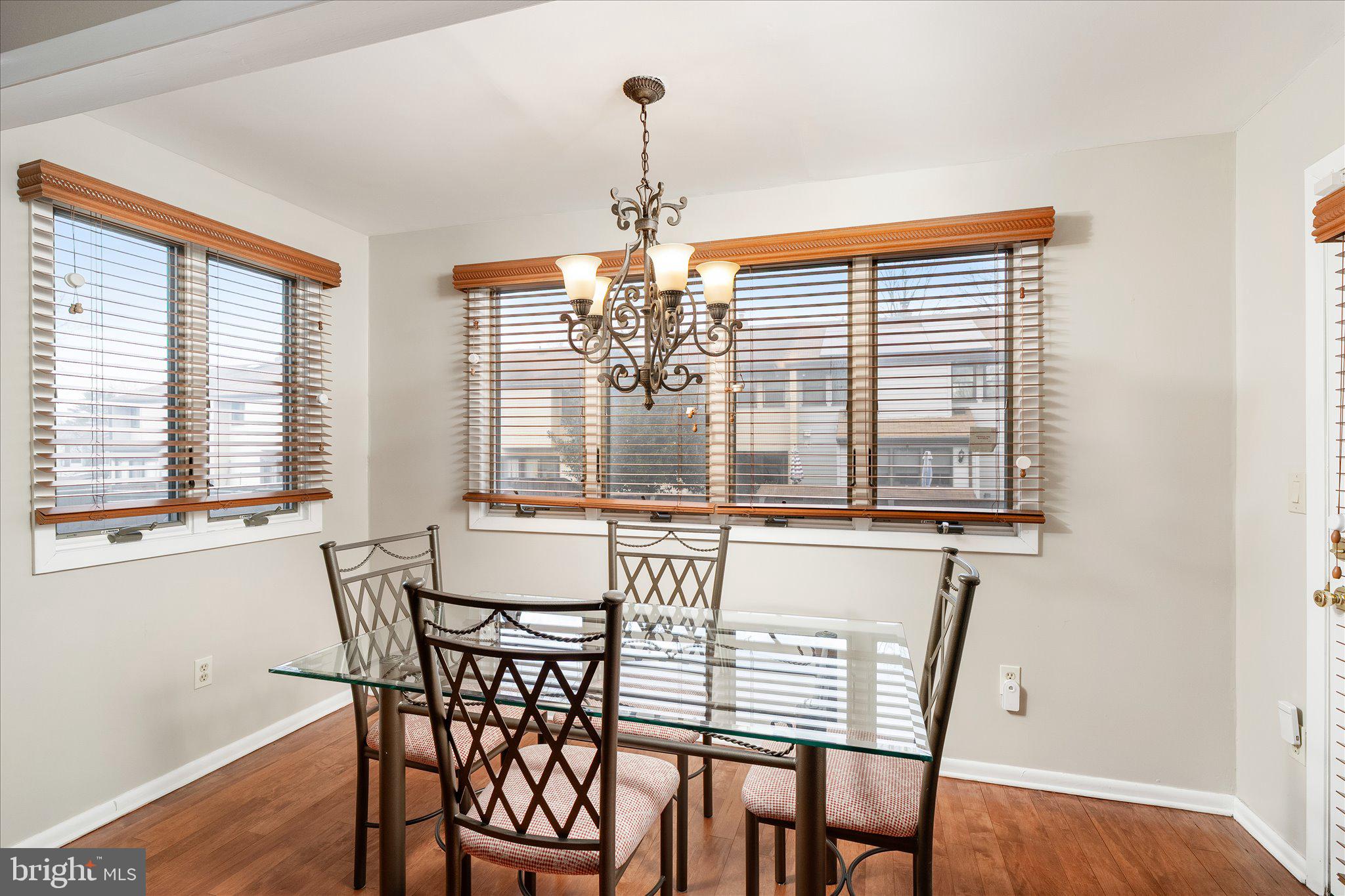 766 Twin Rivers Drive North East Windsor, NJ 08520 - Photo 17 of 31 a view of a dining room with furniture windows and wooden floor
