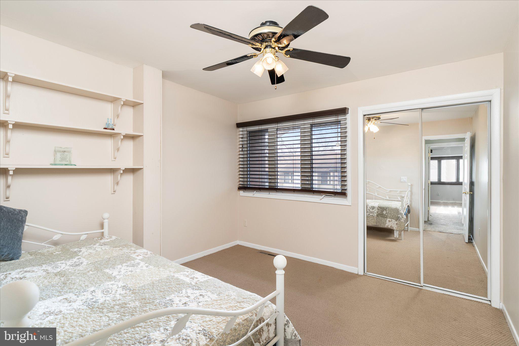 766 Twin Rivers Drive North East Windsor, NJ 08520 - Photo 20 of 31 a view of a bedroom with wooden floor and a ceiling fan