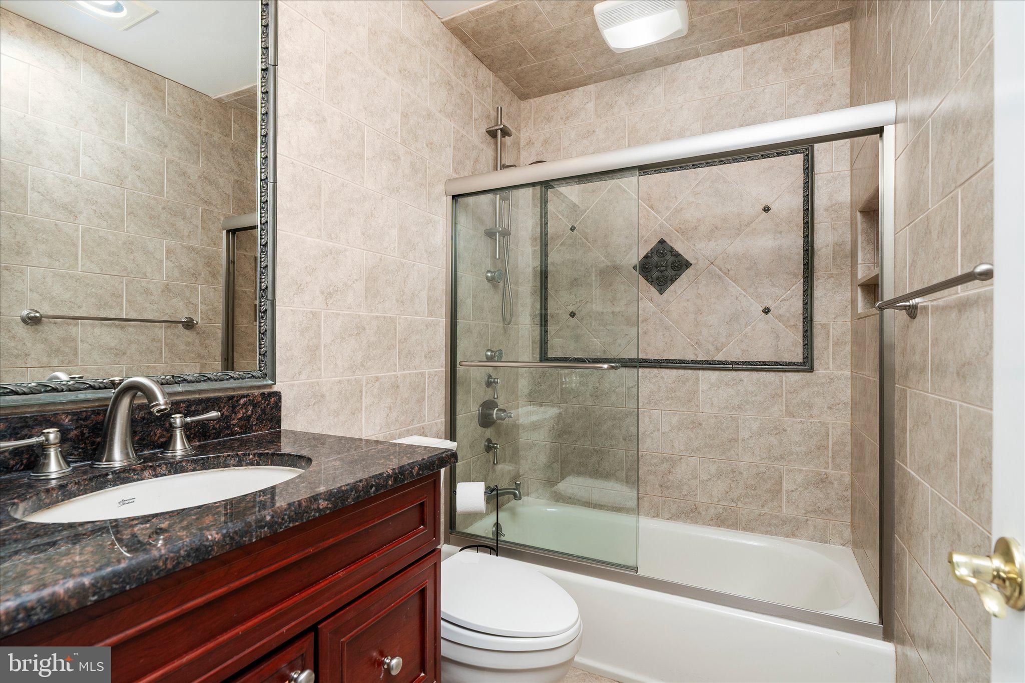 766 Twin Rivers Drive North East Windsor, NJ 08520 - Photo 22 of 31 a bathroom with a granite countertop sink toilet and shower