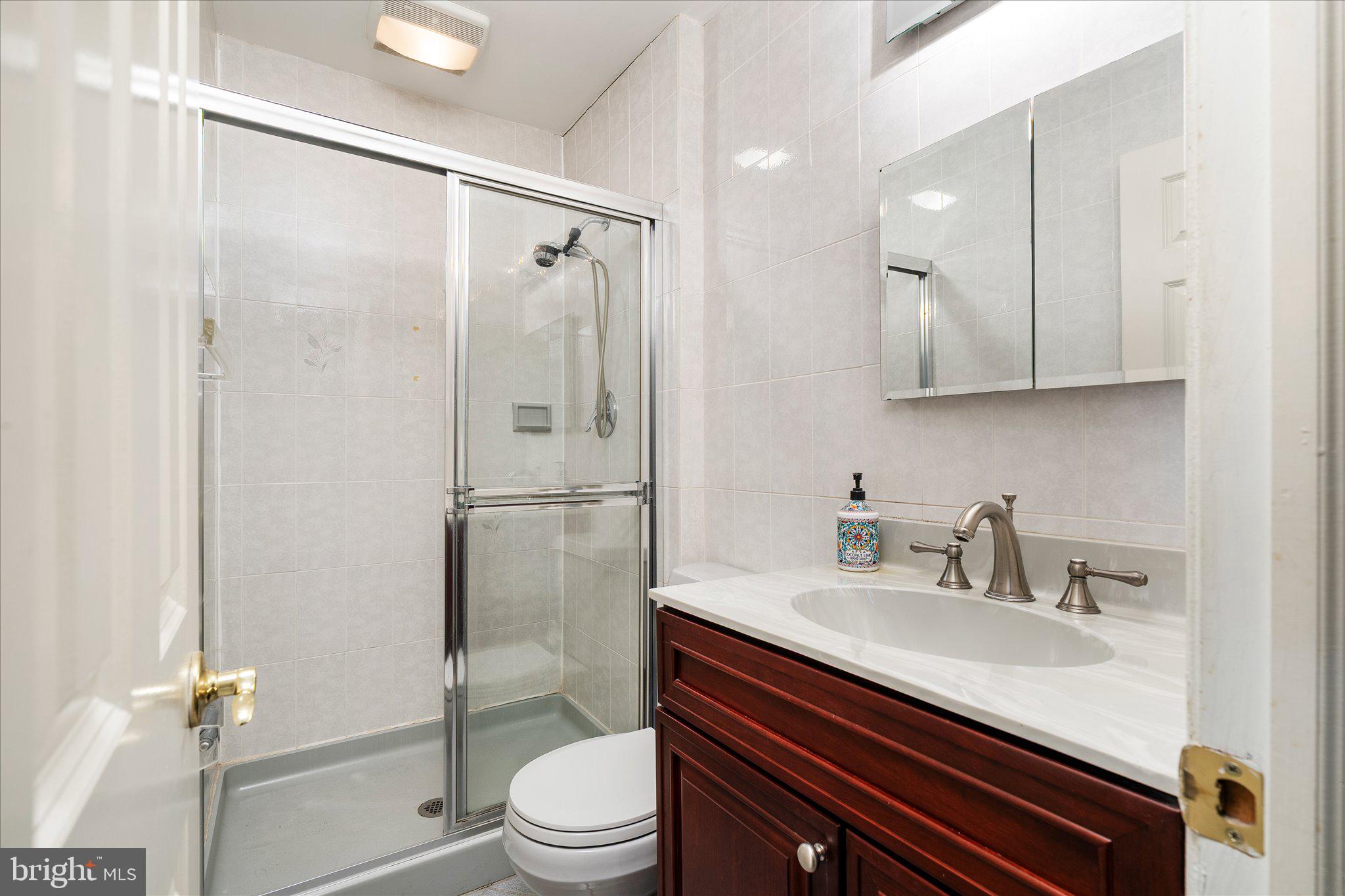 766 Twin Rivers Drive North East Windsor, NJ 08520 - Photo 26 of 31 a bathroom with a sink a toilet and shower