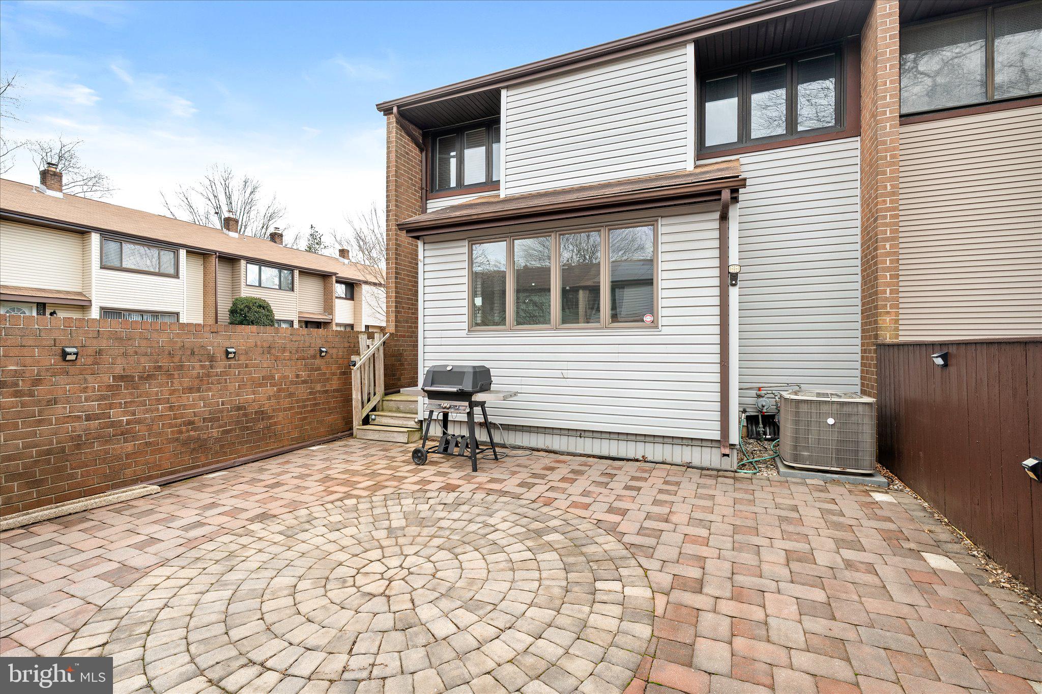 766 Twin Rivers Drive North East Windsor, NJ 08520 - Photo 31 of 31 a backyard of a house with table and chairs