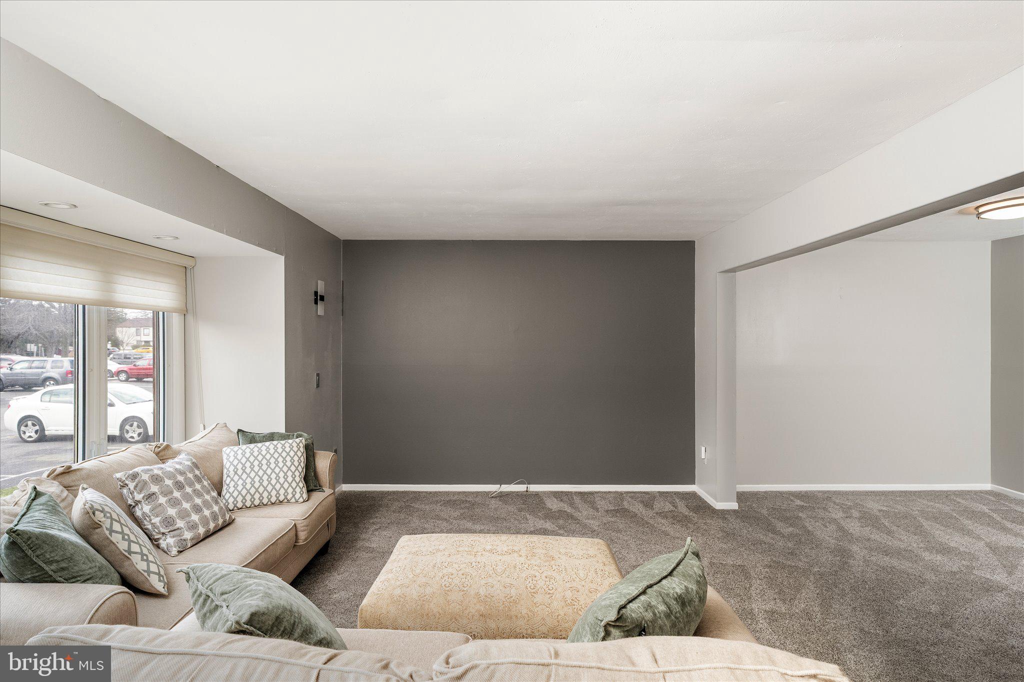 766 Twin Rivers Drive North East Windsor, NJ 08520 - Photo 5 of 31 a living room with furniture and a rug