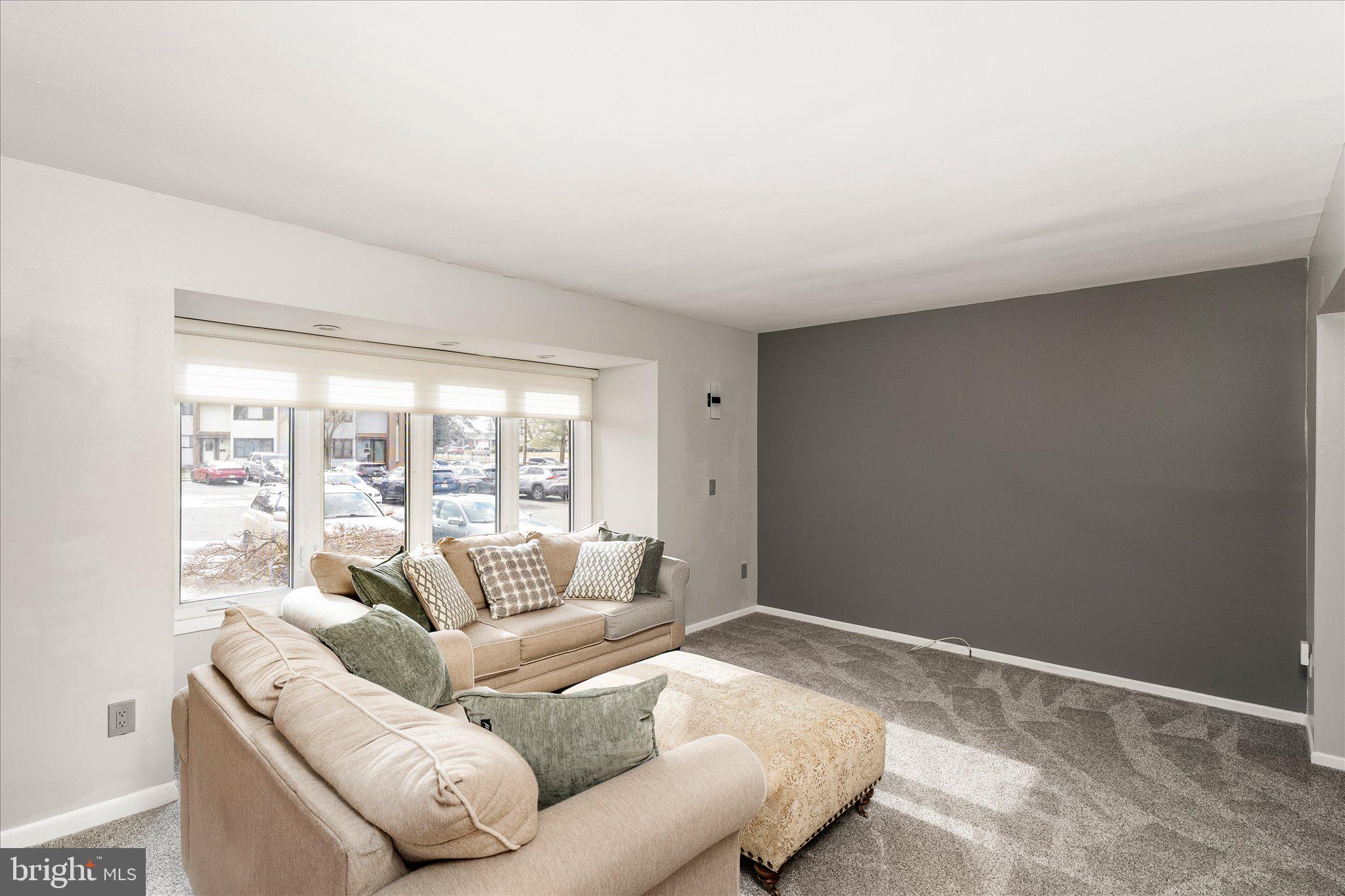 766 Twin Rivers Drive North East Windsor, NJ 08520 - Photo 6 of 31 a living room with furniture and a large window