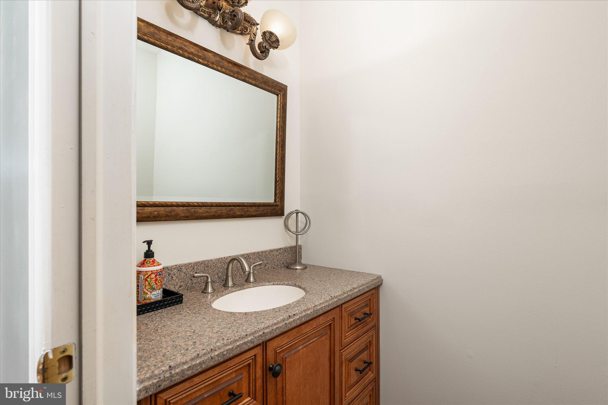 766 Twin Rivers Drive North East Windsor, NJ 08520 - Photo 10 of 31 a bathroom with a granite countertop sink and a mirror