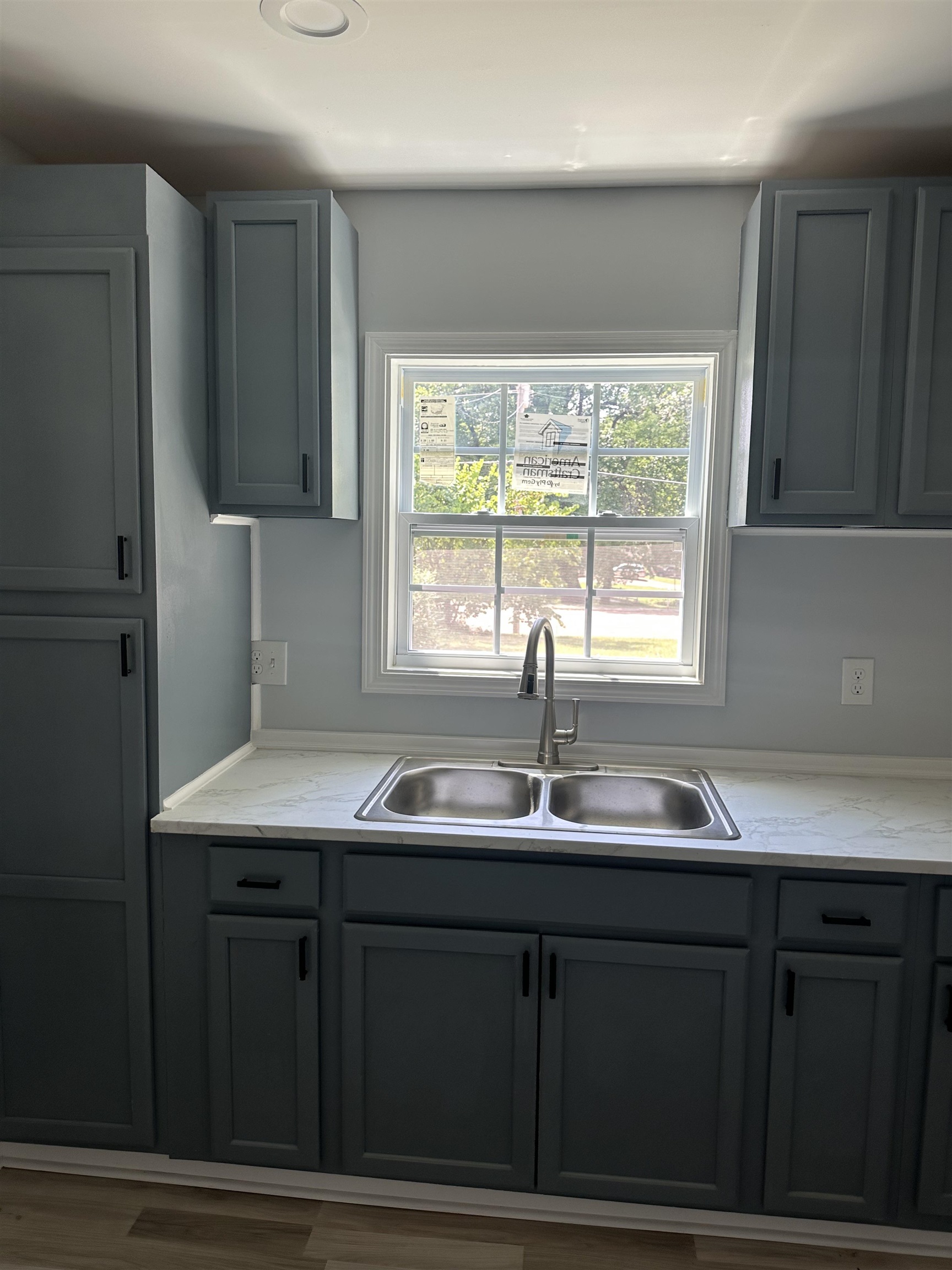 3402 Lakeview Road Memphis, TN 38116 - Photo 4 of 30 Kitchen with gray cabinetry, plenty of natural light, and wood finished floors
